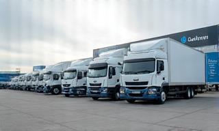 Commercial truck fleet at depot, ready for motorway travel